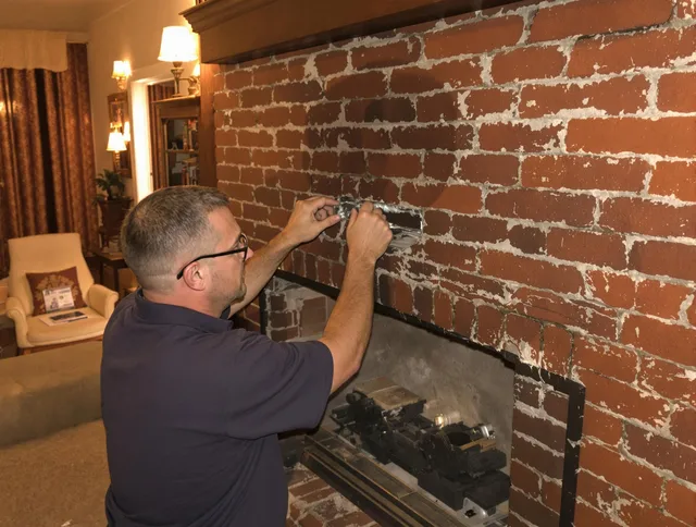 Swampscott Chimney Sweep expert fixing a fireplace in Swampscott, MA